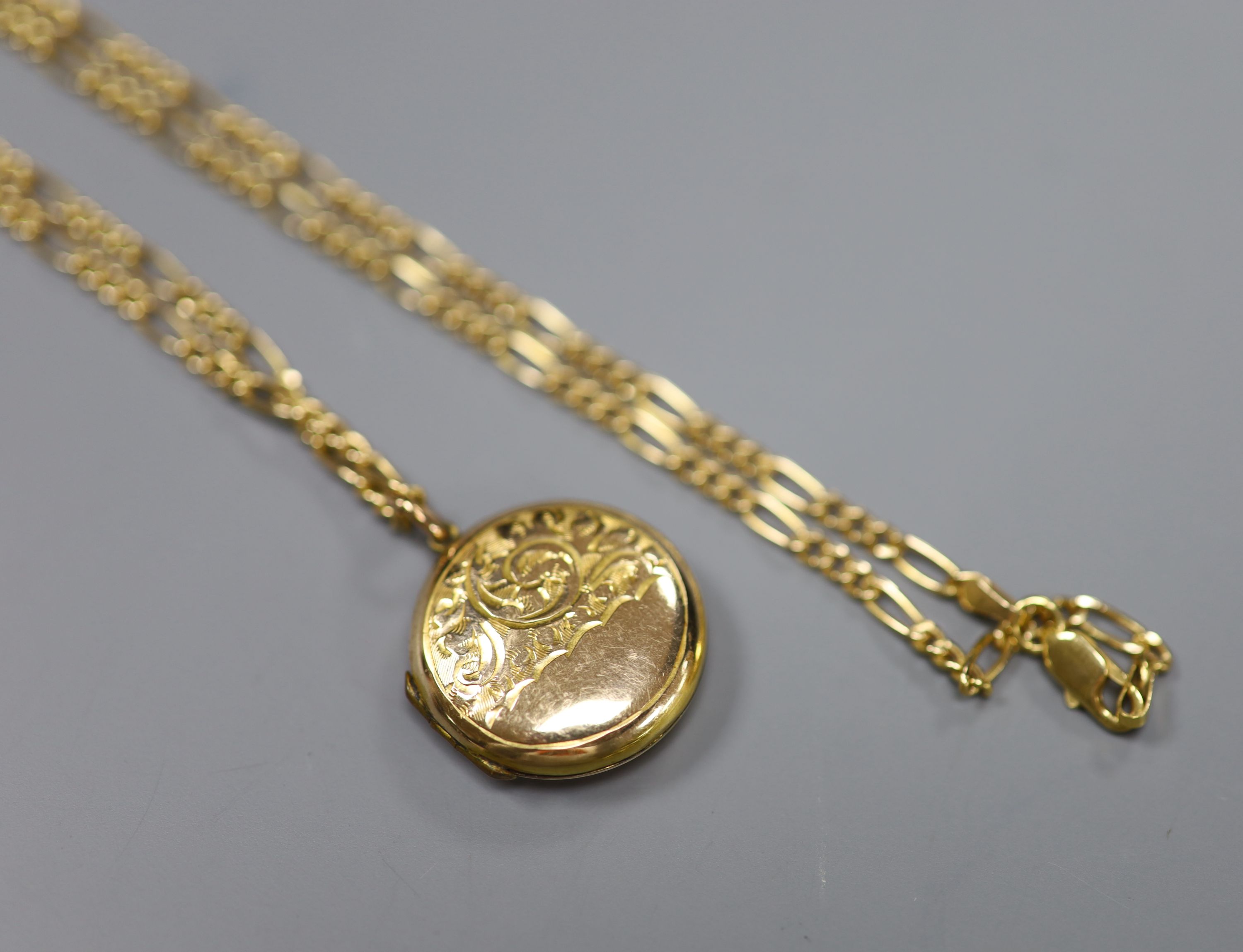 A 585 fancy link chain necklace (5.9g) with 9ct engraved gold enclosed circular locket, gross 10.7g